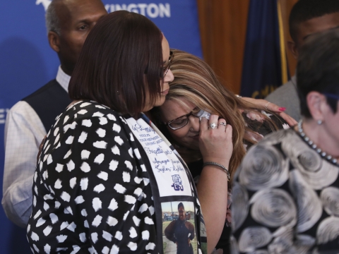 While wiping away tears, Deana Howard is comforted by Prisilla Sandifer. Both women lost children to gun violence. 