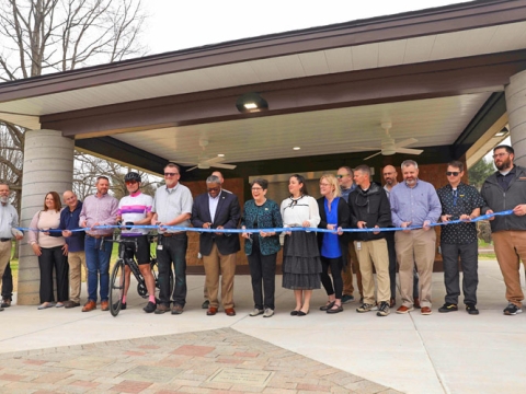 City employees cut a ribbon to open a new building at Ecton Park