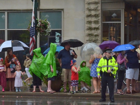 People standing with umbrellas downtown in the rain